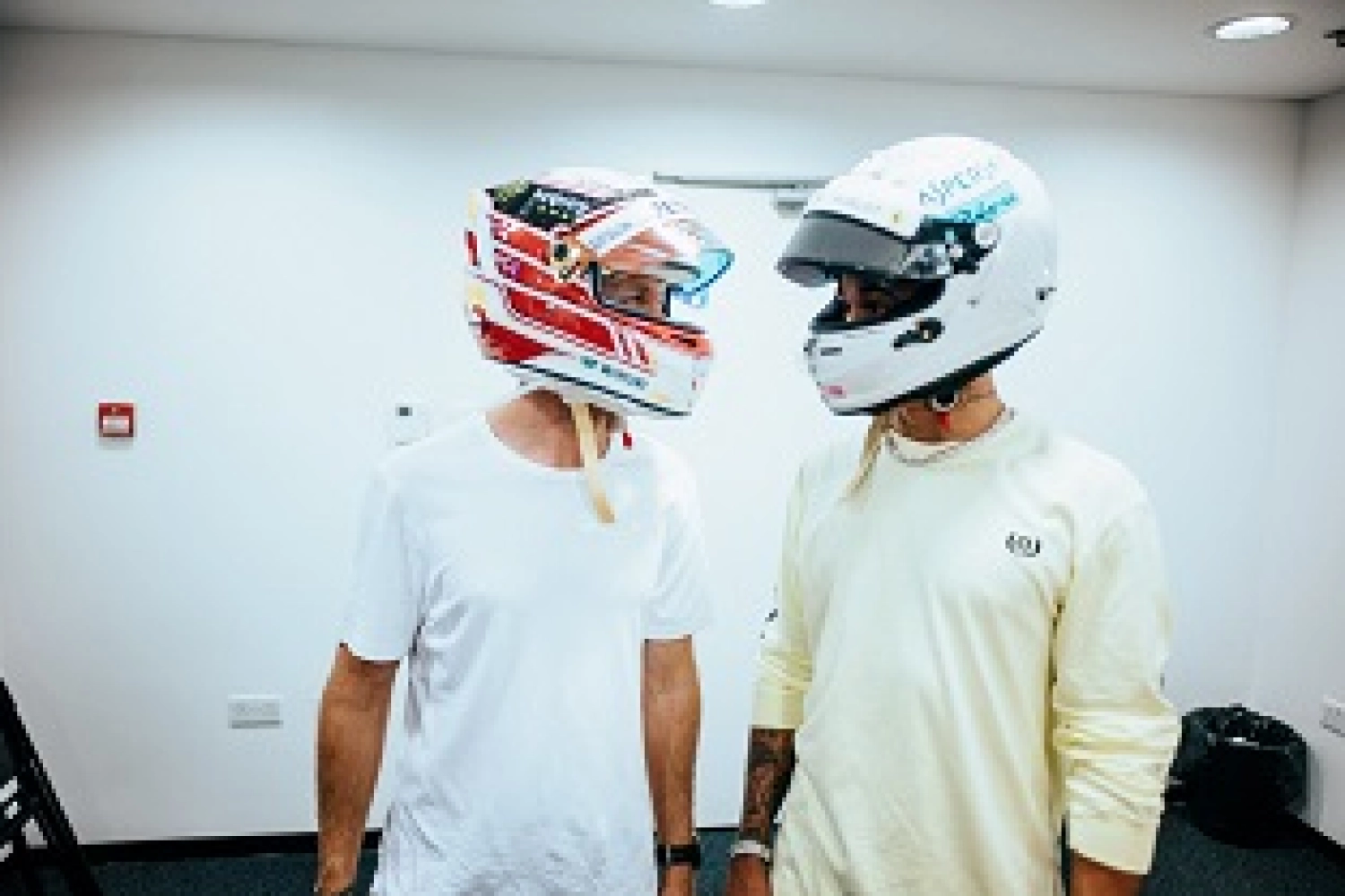 Hamilton and Vettel exchange helmets after the race