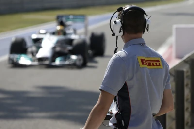 A Pirelli technician watches the track action