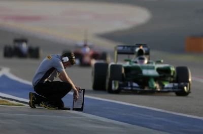 A Pirelli technican takes the temperature in the pit lane